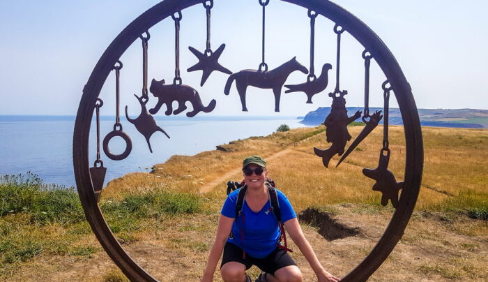 Sine from the Absolute Escapes team with the Charm Bracelet sculpture at Saltburn on the Cleveland Way by artist, Richard Farrington (credit - Sine Birkedal Nielsen)