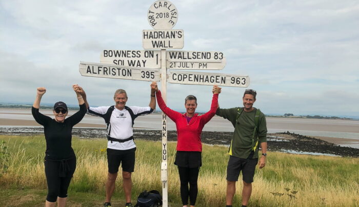 Absolute Escapes clients at the signpost near Bowness-on-Solway (credit - Martin Arvesen)