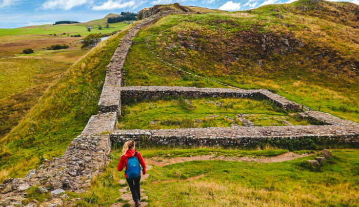 Zoe from the Absolute Escapes team walking through Milecastle 39 on Hadrian's Wall Path