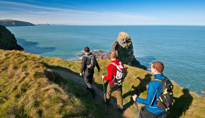 Three walkers on Pembrokeshire Wales Coast Path