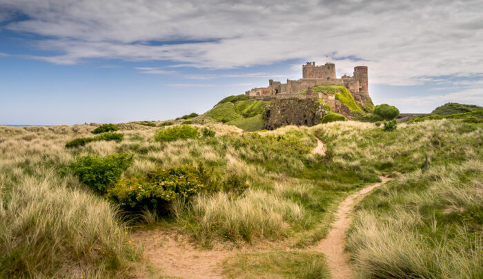 Bamburgh Castle through the sand dunes