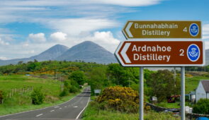 Road sign on Islay with Paps of Jura in background