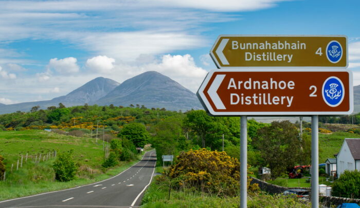 Road sign on Islay with Paps of Jura in background