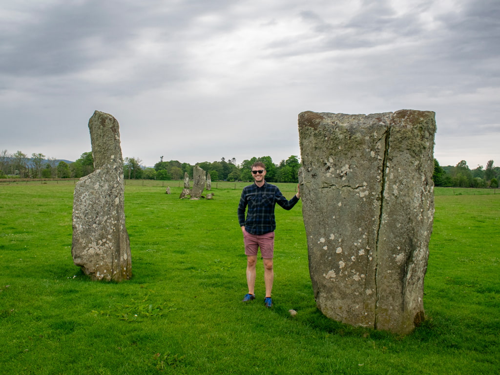 Man at Kilmartin Glen standing stones in Scotland
