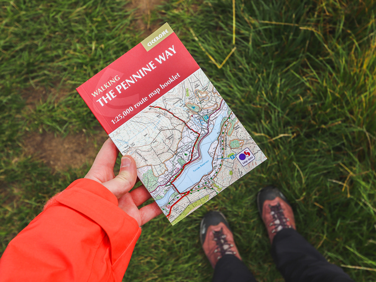 Walker holding Pennine Way guidebook