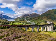 Jacobite Steam Train crossing the Glenfinnan Viaduct in Scottish Highlands