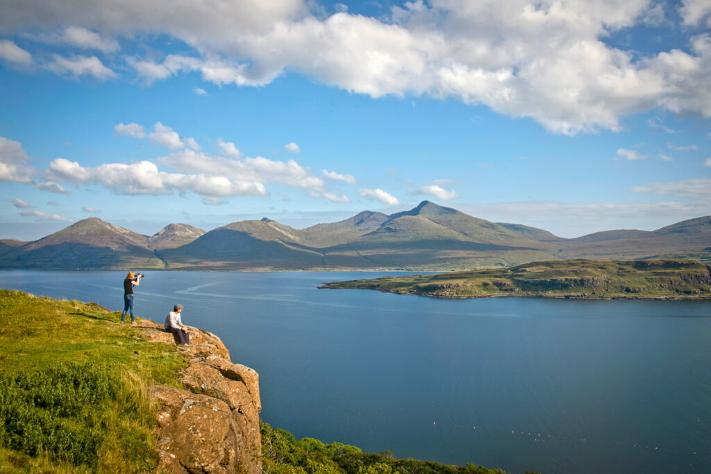 Couple on Mull looking out to the Island of Eorsa, Scotland